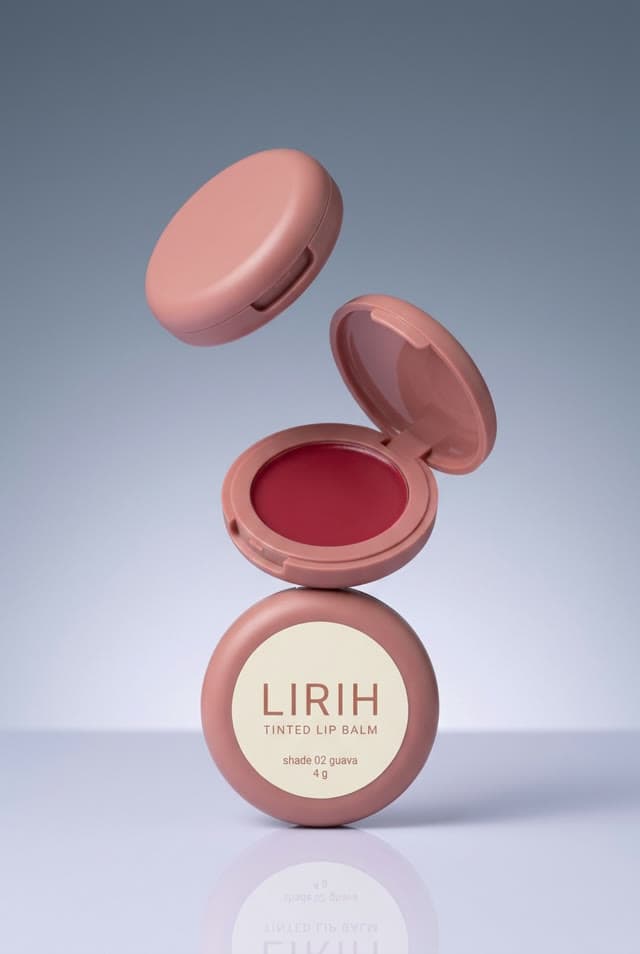 LIRIH tinted lip balm compacts, one open on top of another, the lid floating above: a studio shot by Lumo